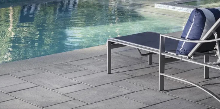 Large modular pavers bring a sophisticated balance of structure and variation, creating outdoor spaces that feel timeless, architectural, and effortlessly refined.