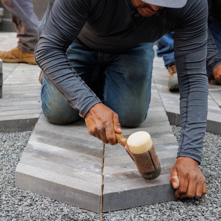 Two men reviewing the construction of a large masonry fireplace