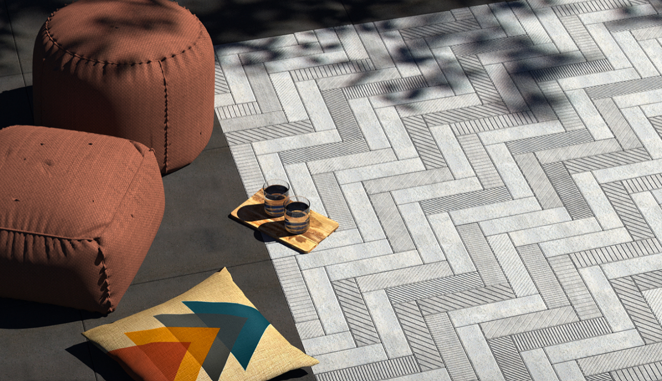 Modern architectural concrete pavers installed in a textured herringbone pattern for a luxury outdoor living space.