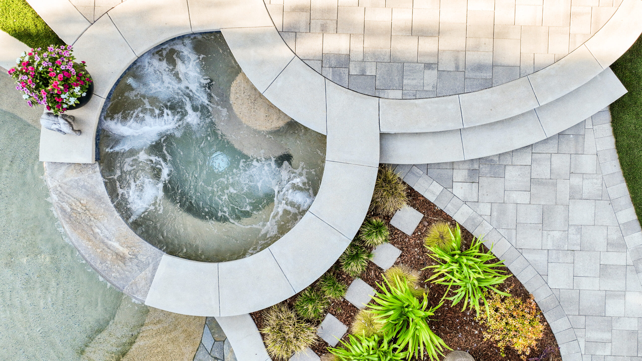 Custom concrete paver pool deck and raised spa with curved masonry detailing in Camarillo, California