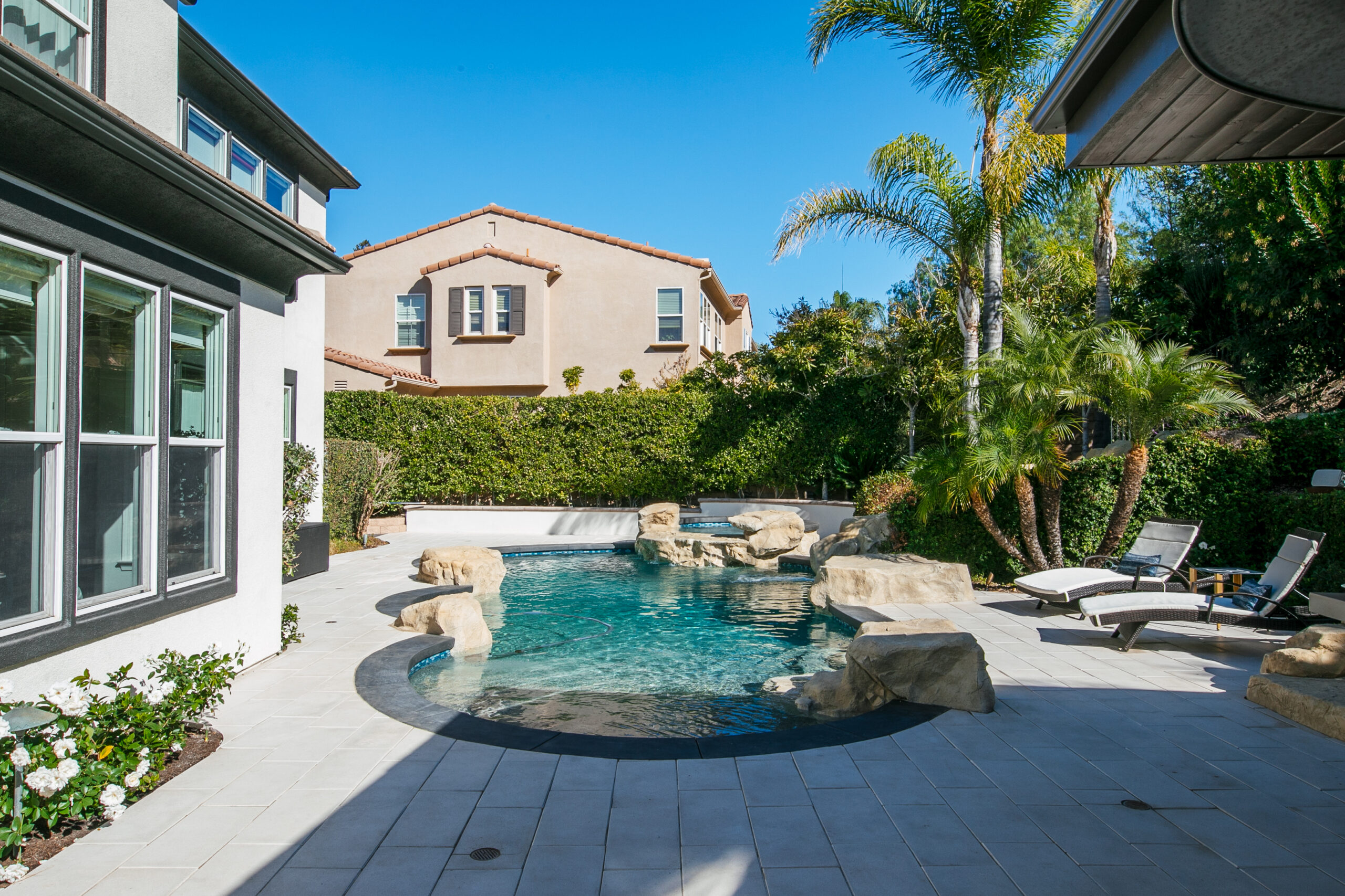 Custom pool deck with large-format concrete pavers surrounding a swimming pool in Thousand Oaks, California.